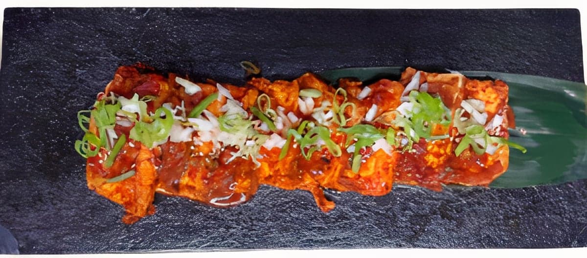Grilled tofu in spicy sauce with scallions and chili