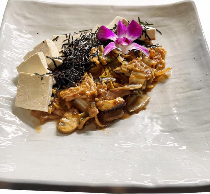 Sauteed kimchi with vegetables and tofu in spicy sauce