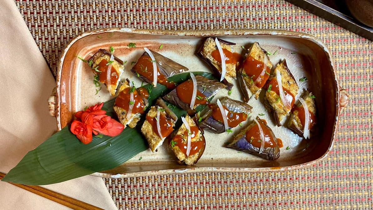 Spicy stuffed eggplant in chili sauce